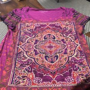 SLIGHTLY LOWER IN THE BACK AT BOTTOM OF SHIRT